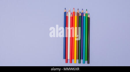 Color Pencils on violet Background for Projects and Announcements. Stock Photo