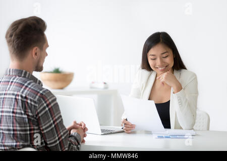 Good impression at interview concept, smiling asian hr reading r Stock Photo