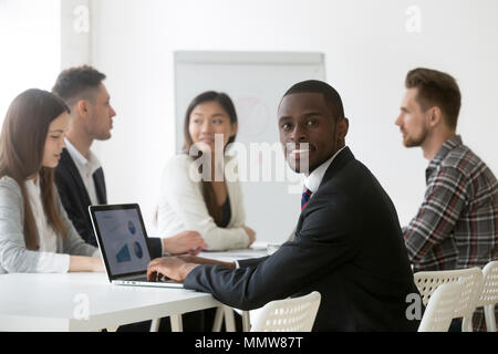 Black financial analyst using laptop analyzing statistics at mee Stock Photo