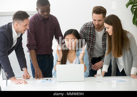 Serious multiracial team discussing solving business problem tog Stock Photo
