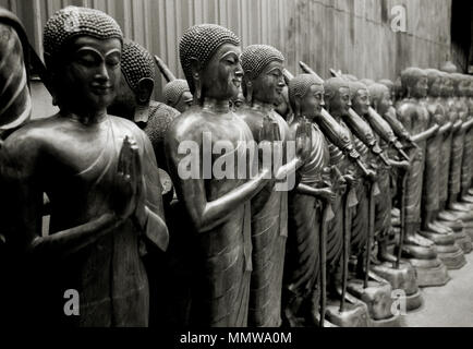 Buddha carving art for sale in Bamrung Muang Road in Bangkok in Thailand Southeast Asia Far East. Buddhist Buddhism Religion Religious Symmetry Stock Photo