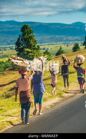 Mostly barefooted Merina villagers walk long distances to the weekly lo cal markets to trade their goods along  the legendary National Route 7 South o Stock Photo