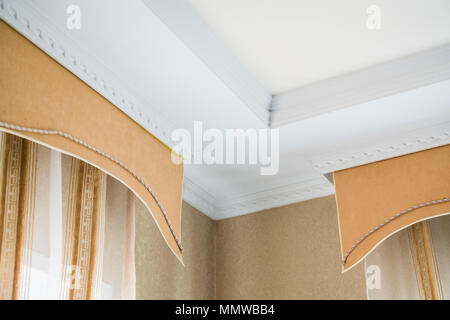 stucco on the ceiling and curtains in rich apartment Stock Photo