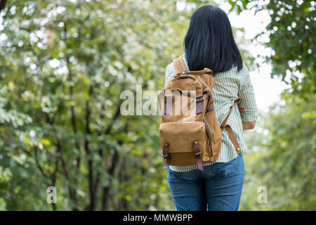 Happy young traveler woman backpacker travel in green natural forest ,greenery fresh air,Freedom wanderlust concept,Alone solo journey. Stock Photo
