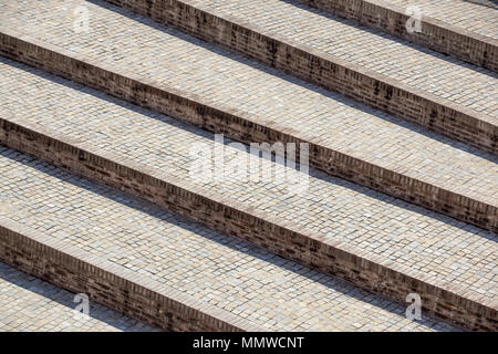 Abstract diagonal stairs, old worn granite staircase on a city square, wide stone stairway perspective often seen near monuments and landmarks. Stock Photo