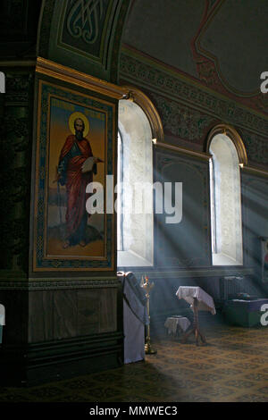 The interior of the church. Beautiful rays of light from the windows make their way into the dark temple. Stock Photo