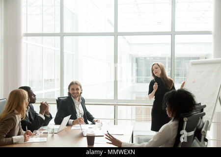 Businesswoman giving presentation for multiracial corporate team Stock Photo