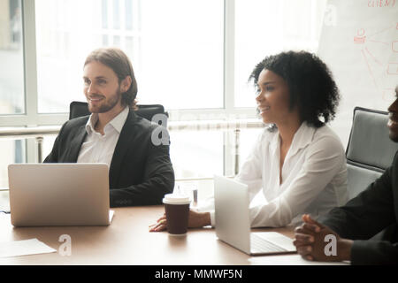 Multiracial smiling business people participating group meeting  Stock Photo