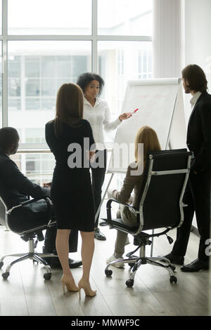 Black team leader teaching diverse business people at group meet Stock Photo