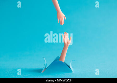 Helping hand to drowning person minimal creative concept. Stock Photo