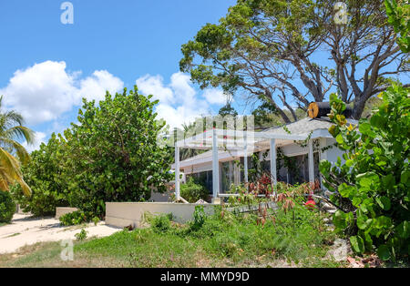 Antigua Lesser Antilles islands in the Caribbean West Indies - Hurricane damaged chalet on beautiful galleon beach by English Harbour Stock Photo