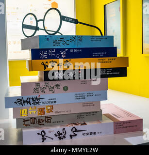 Stack of classic Chinese literature books, with reading glasses Stock Photo