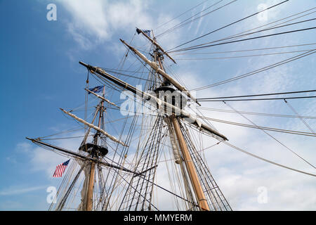 Tall ship masts and rigging against a grey cloudy sky Stock Photo - Alamy