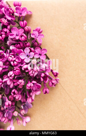 Sprigs of Lilac in postal envelope on wooden background. copy space.spring mood. international women's day. the freshness of flowers.The inscription o Stock Photo