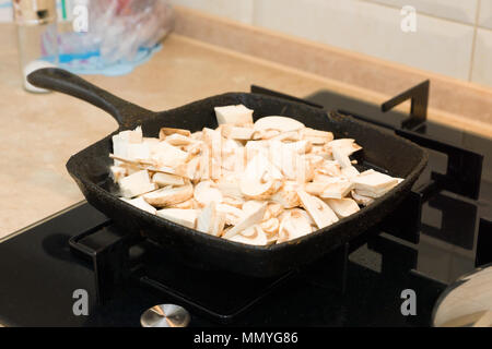 mushrooms are fried on a cast-iron frying pan Stock Photo