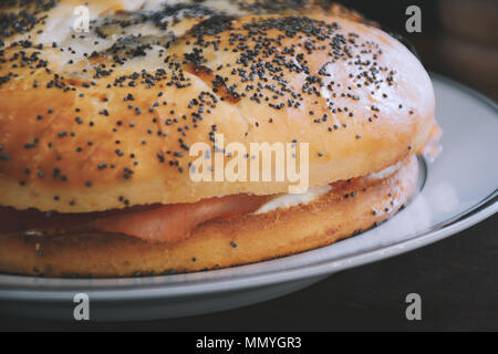 Smoked salmon bagel with cream cheese. Tasty food concept Stock Photo