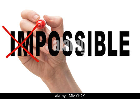 Man crossing out the letters "im" from the word impossible. Success and challenge concept. Stock Photo