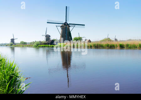 dutch windmill over river waters Stock Photo