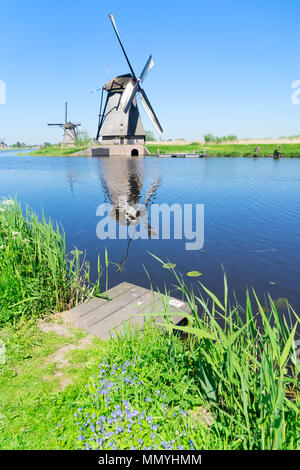 dutch windmill over river waters Stock Photo