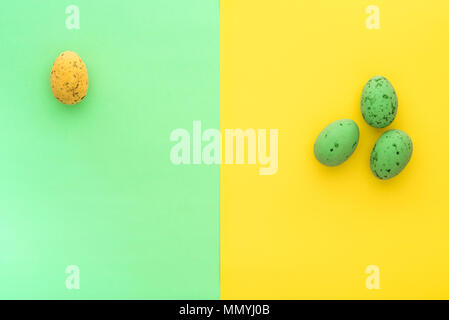 Mini speckled easter eggs from above on colourful backgrounds, with copyspace. Stock Photo