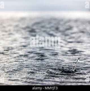 rain drops landing on a pool in st barts Stock Photo