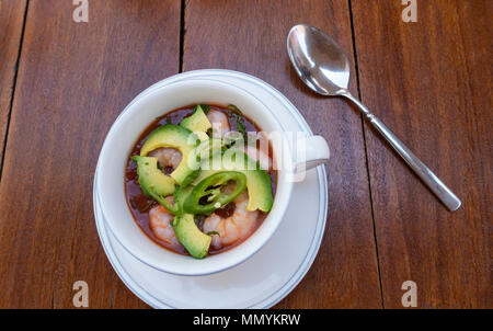 A large cup of spicy avocado and shrimp soup Stock Photo