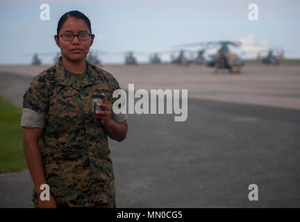 Lance Cpl. Jeanette E. Fernando holds a jar of sand taken from her trip to Iwo Jima, August 1, 2017, at Marine Corps Air Station Futenma, Okinawa, Japan. Fernando and other Marines in her squadron were given the opportunity to revisit the battlegrounds at which Fernando's grandfather, a Navajo Code Talker, fought during World War II. Fernando is an airframe mechanic assigned to Marine Light Attack Helicopter Squadron 169, Marine Aircraft Group 39, 3rd Marine Aircraft Wing, currently on a unit deployment program with 1st MAW based in Okinawa, Japan. (U.S. Marine Corps photo by Lance Cpl. Andy M Stock Photo