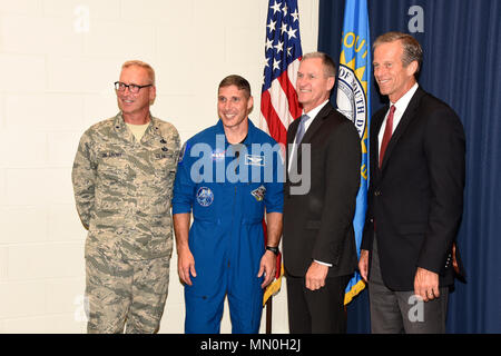 Colonel Michael Hopkins, NASA Astronaut, posed for a photo with Brig. Gen. Joel De Groot, SDNG assistant adjutant general for air, Gov. Dennis Daugaard, and U.S. Sen. John Thune here, Aug. 4.  Hopkins shared his experiences as an astronaut with members of the 114th Fighter Wing.  (U.S. Air National Guard photo by Master Sgt. Christopher Stewart/Released) Stock Photo