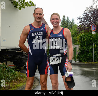 Air Force Lt. Col. Jon Mason (left) and Air Force Maj. Judy Coyle pose after placing second and first, respectively in their divisions, at the 2017 World Military Triathlon Championship in Sassenberg, Germany Aug. 5, 2017. The competition is hosted annually by the International Military Sports Council and consists of 22 different nations’ militaries competing against each other in a triathlon. (U.S. Marine Corps photo by Lance Cpl. Troy Saunders/Released) Stock Photo