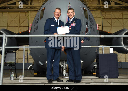 Col. Howard Wagner, the former commander of the 105th Airlift Wing, is presented the Legion of Merit during a change of command ceremony at Stewart Air National Guard Base, Newburgh, New York Aug. 6, 2017. The medal is awarded to those who distinguished themselves by exceptionally meritorious conduct in the performance of outstanding service. (U.S. Air Force photo by Senior Airman Terrence Clyburn) Stock Photo