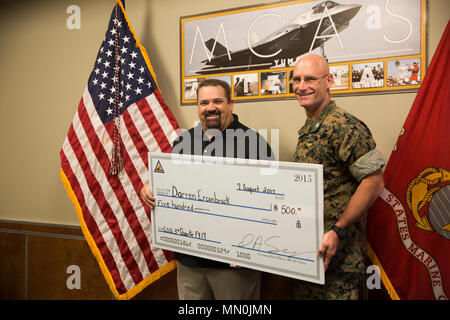 U.S. Marine Corps Col. David Suggs (right), the commanding officer of Marine Corps Air Station Yuma, Ariz., recognizes Darren Ercanbrack (left), MCAS Yuma’s Air Traffic Control (ATC) supervisor, as the MCAS Yuma Employee of the 3rd Quarter, Aug. 7, 2017. (U.S. Marine Corps photo taken by Pfc. Sabrina CandiaFlores) Stock Photo