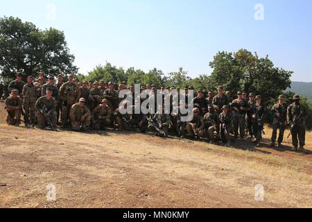 U.S. Marines with Black Sea Rotational Force 17.1 and Ukrainian soldiers pose for a group photo after a combined company attack exercise aboard Novo Selo Training Area, Bulgaria, Aug. 7, 2017. The event was part of Exercise Platinum Lion 17.2, a multinational exercise designed to build interoperability between NATO Allies and partner nations. (U.S. Marine Corps photo by Sgt. Patricia A. Morris) Stock Photo