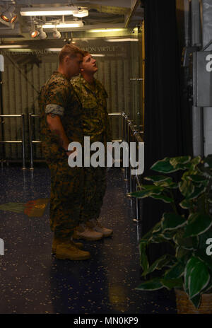 MAYPORT, Fla. (August 3, 2017) Marine Master Sgt. James Bishop and Lt. George Gagnon, attached to Expeditionary Warfare Training Group, Atlantic, view photos in the Suribachi Room aboard the amphibious assault ship USS Iwo Jima (LHD 7). Iwo Jima is in port conducting a scheduled continuous maintenance availability in preparation for their upcoming deployment. (U.S. Navy photo by Mass Communication Specialist Seaman Dary M. Patten/Released) Stock Photo