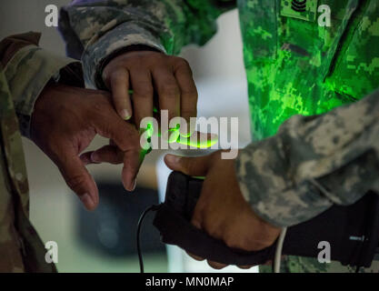 200th Military Police Command is a U.S. Army Reserve organization responsible for detention and law enforcement support. The archival image documents a fingerprint scan demonstration using the BAT-A biometrics system at Fort Indiantown Gap, Pennsylvania, on Aug. 2, 2017. Stock Photo