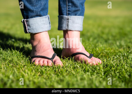 Woman wearing flip flops on a meadow Stock Photo