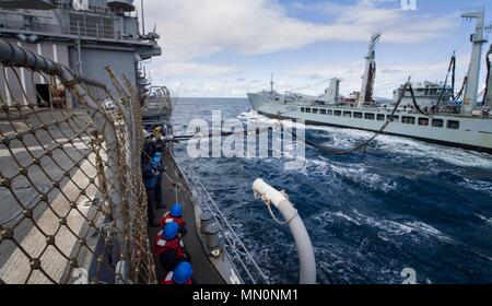 170805-N-HV059-129  SEA OF HEBRIDES (Aug. 5, 2017) Sailors aboard the Ticonderoga-class guided-missile cruiser USS Leyte Gulf (CG 55) receive a refueling probe from the British replenishment oiler RFA Wave Ruler (A390) while conducting a replenishment-at-sea during exercise Saxon Warrior 2017. The U.S. and United Kingdom co-hosted carrier strike group exercise demonstrates interoperability and capability to respond to crises and deter potential threats. (U.S. Navy photo by Mass Communication Specialist 2nd Class Sonja Wickard/Released) Stock Photo