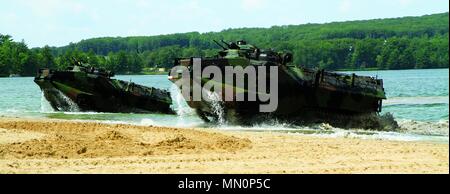 Two Amphibious Assault Vehicles (AAV) storm the beach coming up from Lake Margrethe, Michigan August 8, 2017. The AAV’s are with the 4th Assault Amphibious Battalion based in Jacksonville, Florida, and are at Camp Grayling Joint Maneuver Training Center performing their annual training during Northern Strike 17. Northern Strike 17 is a National Guard Bureau-sponsored exercise uniting approximately 5,000 service members from 13 states and five coalition countries during the first two weeks of August 2017 at the Camp Grayling Joint Maneuver Training Center and the Alpena Combat Readiness Trainin Stock Photo