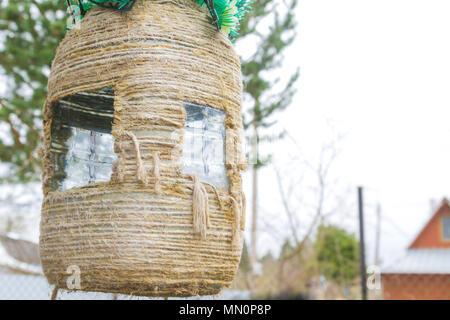 Homemade birdhouse made of plastic bottle and rope Stock Photo