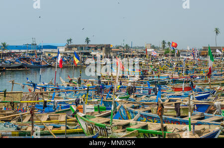 Elmina, Ghana - February 13, 2014: Colorful moored wooden fishing boats in African harbor town Elmina Stock Photo