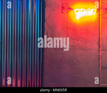 a very bright orange neon sign that signs open but is barely visible due to its brightness Stock Photo