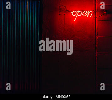 red neon open sign shot at night on the outside of a building in Portland, Maine Stock Photo