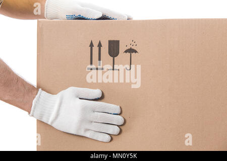Moving things background. Hands of worker on carton box close-up on white background. Stock Photo