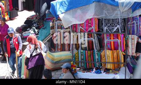 Indigenous woman selling her weavings and crafts in the Plaza de los Ponchos Stock Photo