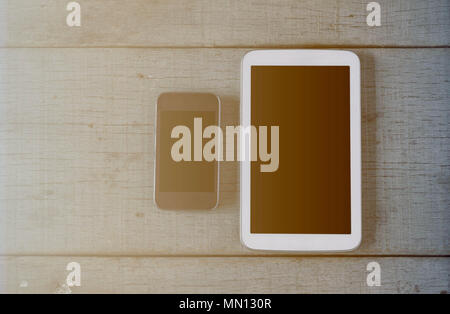 Phones and tablets on the old wooden floor. Stock Photo
