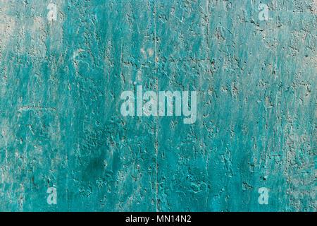 Weathered blue, green painted wall background, partially faded. Corroded, peeled, vintage, blank wall for backdrop. Close up view with details. Stock Photo