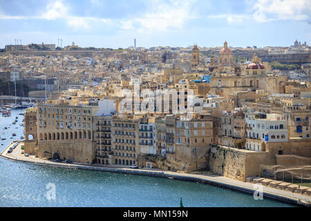 Malta, Valletta. Senglea, a fortified grand harbour that is surrounded of boats and ships, under a blue sky with few clouds. Panoramic view. Stock Photo