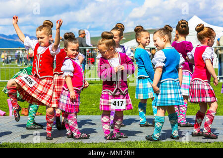 Gourock, UK. 13th May 2018. Gourock starts off the 'Games' season with hundreds of pipers, 'heavies' and dancers from across the country, all competing in traditional Scottish Highland Games that include pipe bands, individual piping, country dancing for all ages and all the traditional heavyweight competitions such as tossing the caber, throwing the hammer and lifting the Keppoch Stone.Thousands of spectators turned out on a fine sunny May Sunday to cheer on all the competitors. Credit: Findlay/Alamy Live News Stock Photo