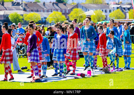 Gourock, UK. 13th May 2018. Gourock starts off the 'Games' season with hundreds of pipers, 'heavies' and dancers from across the country, all competing in traditional Scottish Highland Games that include pipe bands, individual piping, country dancing for all ages and all the traditional heavyweight competitions such as tossing the caber, throwing the hammer and lifting the Keppoch Stone.Thousands of spectators turned out on a fine sunny May Sunday to cheer on all the competitors. Credit: Findlay/Alamy Live News Stock Photo