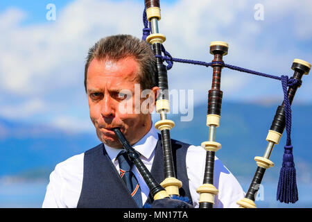 Gourock, UK. 13th May 2018. Gourock starts off the 'Games' season with hundreds of pipers, 'heavies' and dancers from across the country, all competing in traditional Scottish Highland Games that include pipe bands, individual piping, country dancing for all ages and all the traditional heavyweight competitions such as tossing the caber, throwing the hammer and lifting the Keppoch Stone.Thousands of spectators turned out on a fine sunny May Sunday to cheer on all the competitors. Credit: Findlay/Alamy Live News Stock Photo