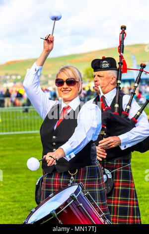 Gourock, UK. 13th May 2018. Gourock starts off the 'Games' season with hundreds of pipers, 'heavies' and dancers from across the country, all competing in traditional Scottish Highland Games that include pipe bands, individual piping, country dancing for all ages and all the traditional heavyweight competitions such as tossing the caber, throwing the hammer and lifting the Keppoch Stone.Thousands of spectators turned out on a fine sunny May Sunday to cheer on all the competitors. Credit: Findlay/Alamy Live News Stock Photo